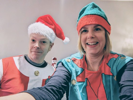 Chris dressed as Santa and Jane as an elf.