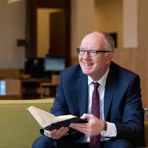 Richard Ovenden sits wiht an open book in his hands